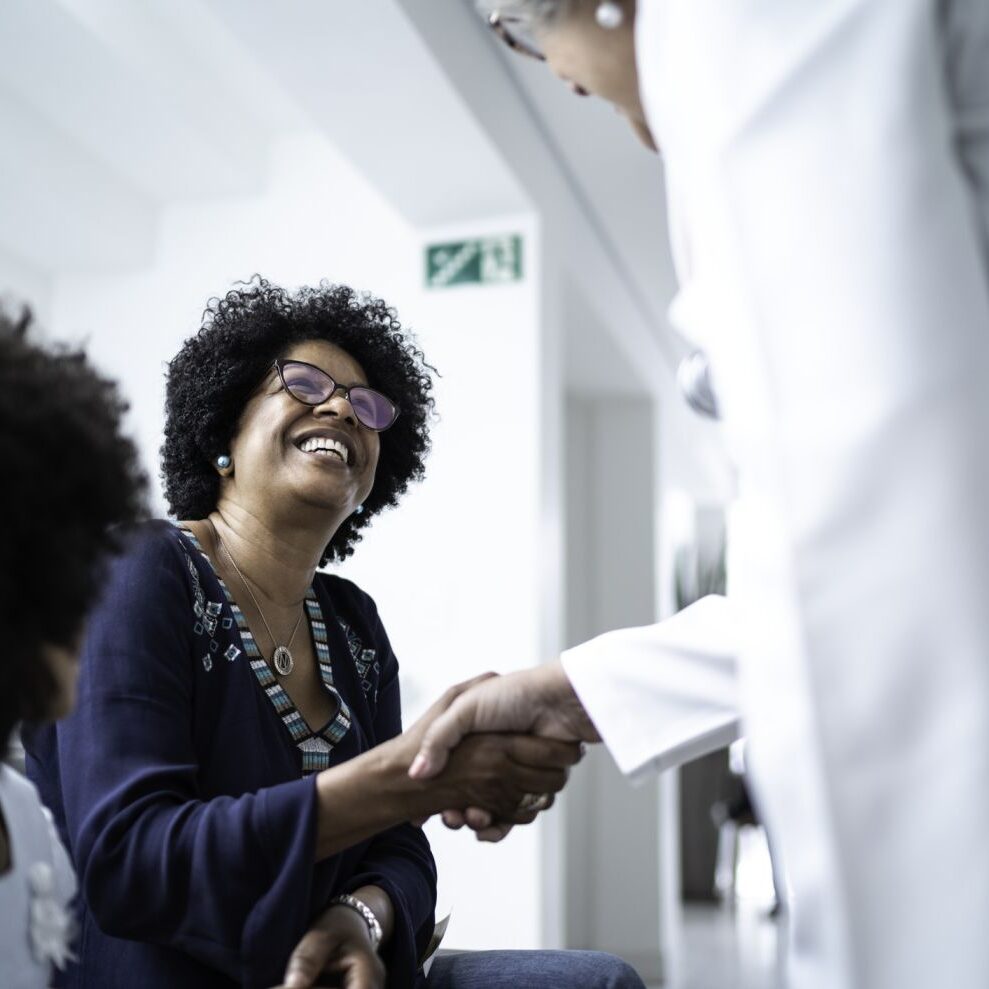 woman meeting with hearing clinic technician